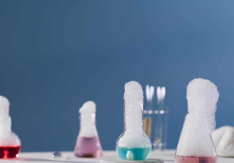 Vibrant chemical reactions in flasks with bubbles in a lab setting.
